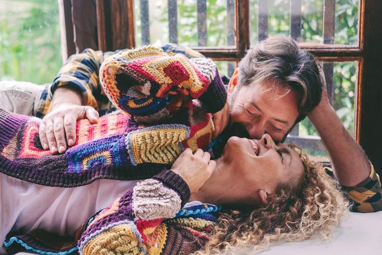 Loving mature couple relaxing at home, sharing affectionate moments and cuddles together, concept of love, relationship, family, tenderness, and quality time