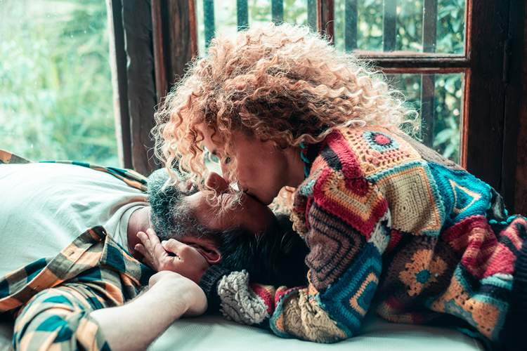 Loving mature couple relaxing at home, sharing affectionate moments and cuddles together, concept of love, relationship, family, tenderness, and quality time